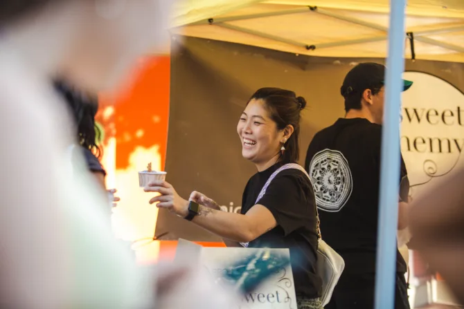 UW Art graduate graduate Lois Ko hands out ice cream from her business, Sweet Alchemy, during the U District Street Fair.