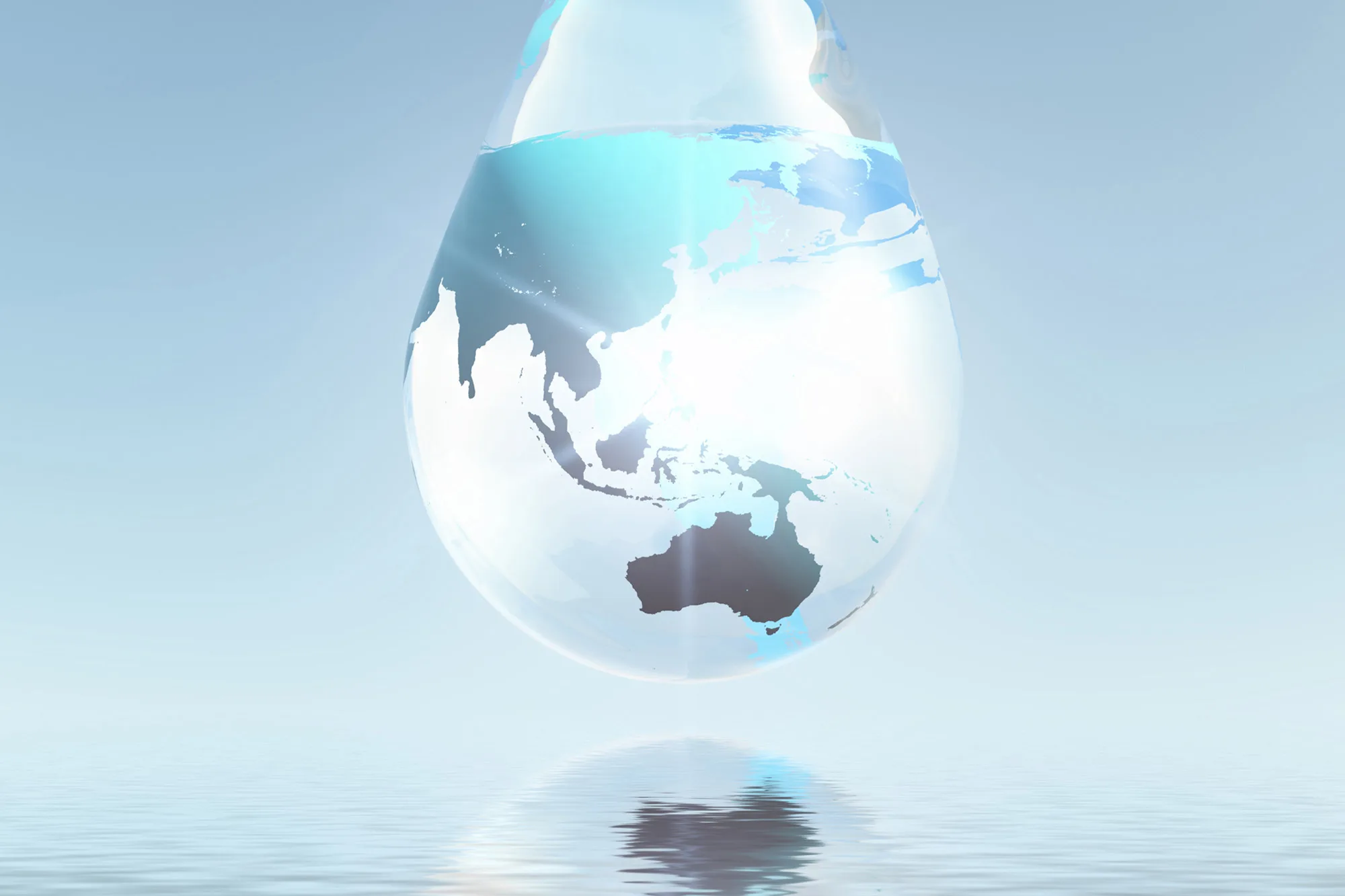 A poster of a water droplet containing a map of the world hovering over a body of water