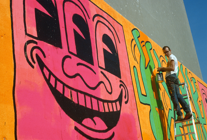 Keith Haring painting a large mural.