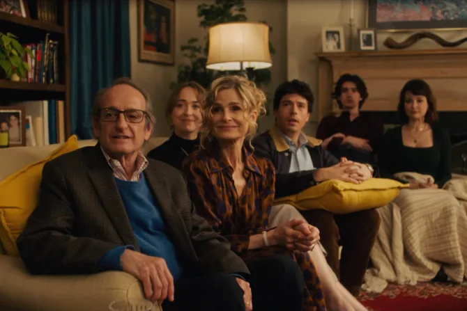 A film still from the film "Bad Shabbos." A family sits, lined up in a living room.