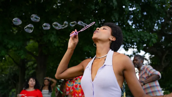 Woman blowing bubbles