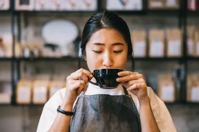 Barista sipping coffee