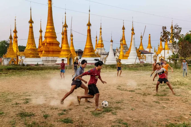 Children playing soccer outdoors