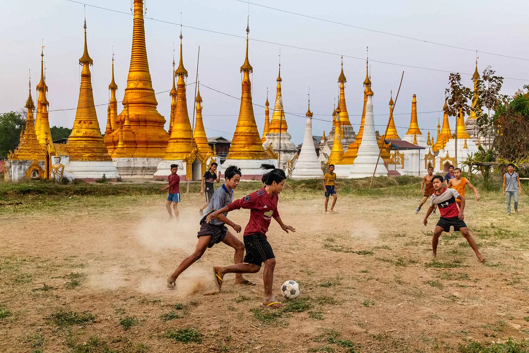 Children playing soccer outdoors