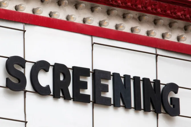 Movie marquee that says "screening"