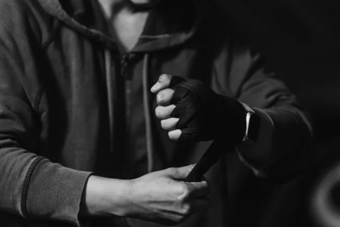 Martial arts fighter putting on gloves