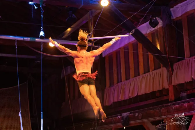 Trapeze artist swinging