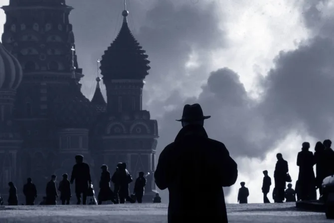 A man in a trench coat in Red Square