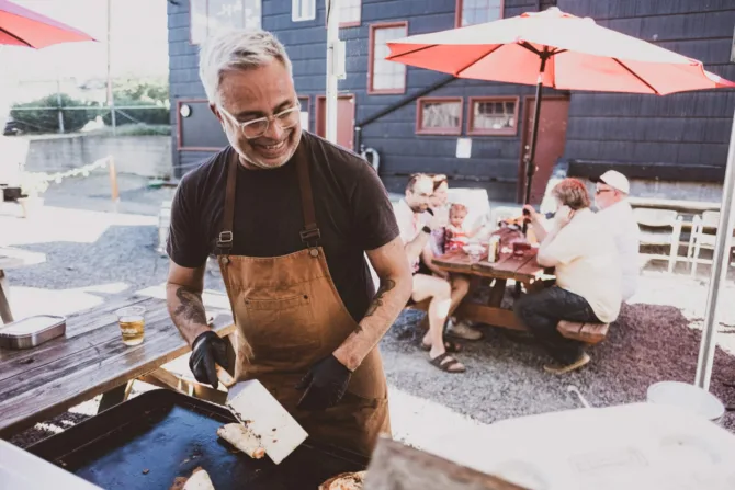 Dave Hernandez cooking over a grill